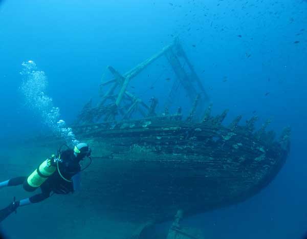 Buzo junto a un barco hundido